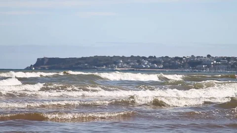 Goodrington Sands, Devon: Slow motion of waves rolling into shore (NO AUDIO) Stock Footage 115910643