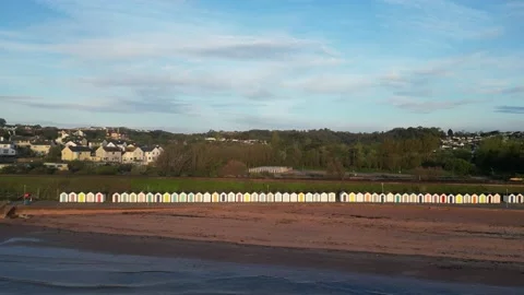 Goodrington Sands, Torbay, Devon, England: DRONE VIEW: Zoom towards beach huts Stock Footage 240096609