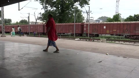A goods train passing throug a Railway station Stock-Footage 52707189