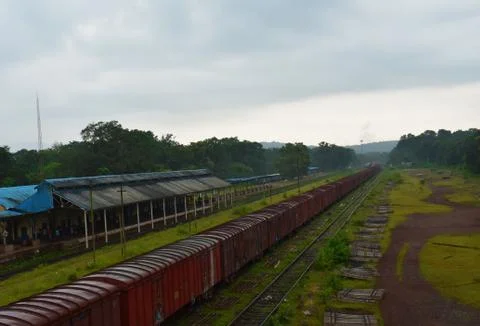 Goods train waiting to leave from a station in a rainy weather Foto stock