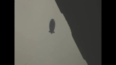 Goodyear blimp rotating in the sky Stock Footage 314054191