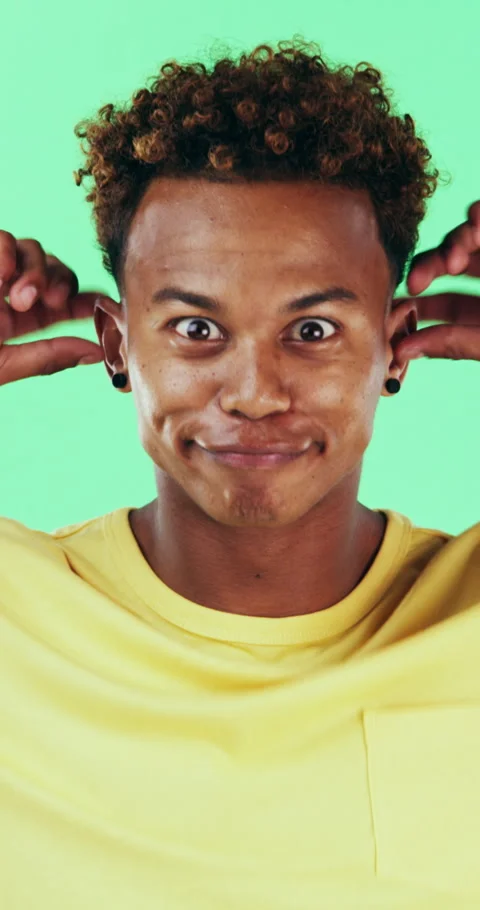 Goofy, funny face and black man on green background for humor, joke and meme in Stock Footage 334934120