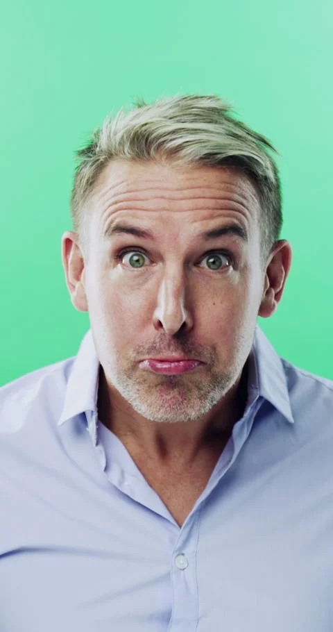 Goofy, funny face and silly man on green background for humor, joke and meme in Stock Footage 334928565