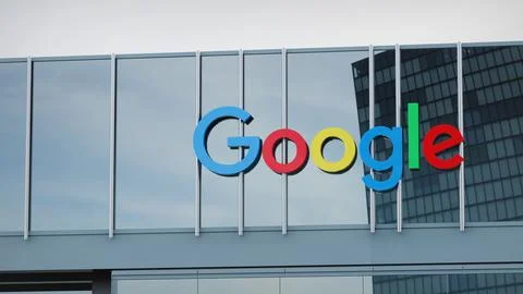Google Alphabet Stock data presented on the logo of the office facade editorial Stock Photos