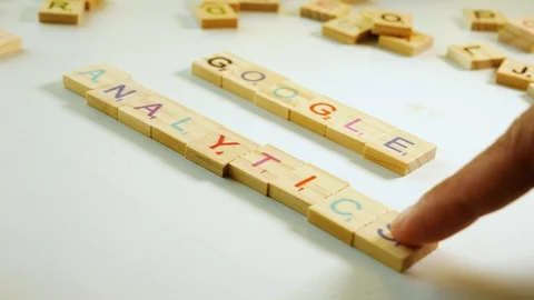 Google Analytics spelled with wooden tiles letters. Off white background. Stock Footage 104912113