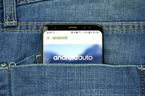 Google Android Auto on a phone screen in a pocket Stock Photos
