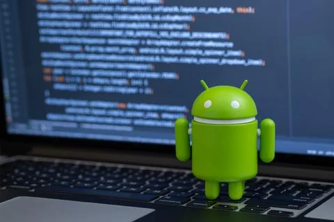 Google Android figure standing on laptop keyboard Stock Photos