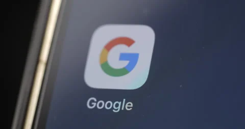 Google app on smartphone’s screen rotating Stockbeeldmateriaal 301257049