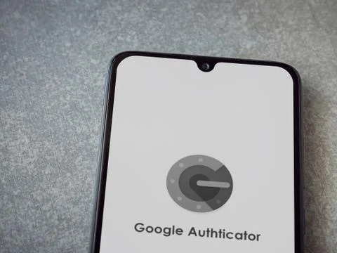 Google Authenticator app launch screen with logo on the display of a black mo Foto stock