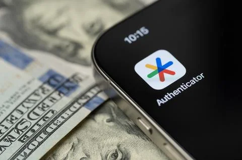 Google Authenticator app on smartphone screen with dollar background Stock Photos