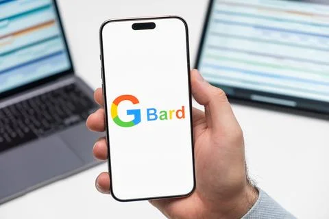Google Bard logo on the screen of mobile phone in mans hand Stock Photos