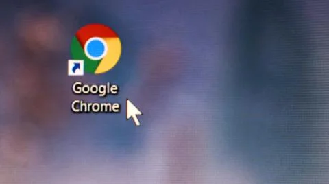 Google Chrome browser application icon on the desktop of a computer screen. Stock Photos