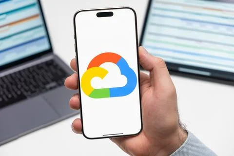 Google Cloud logo on the screen of mobile phone in mans hand Stock Photos