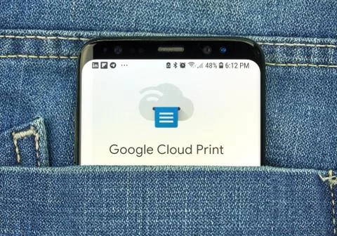 Google Cloud Print on a phone screen in a pocket Stock Photos