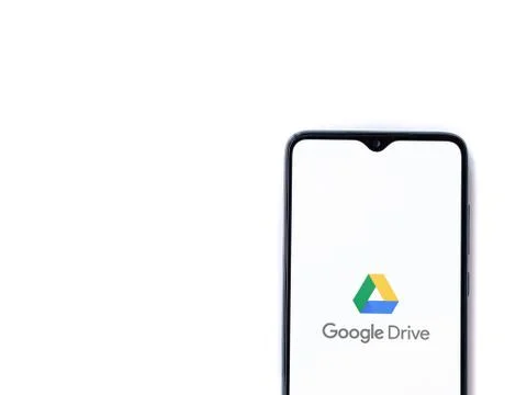 Google Drive app launch screen with logo on the display of a black mobile sma Stock Photos