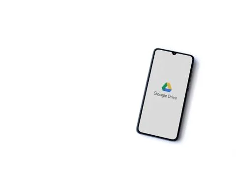 Google Drive app launch screen with logo on the display of a black mobile sma Stock Photos