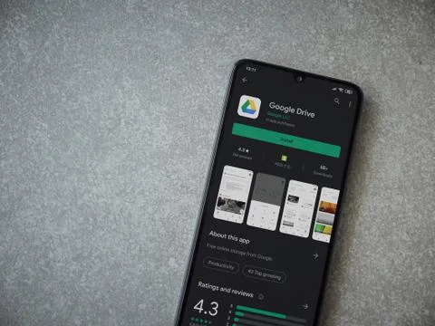 Google Drive app play store page on the display of a black mobile smartphone  Stock Photos