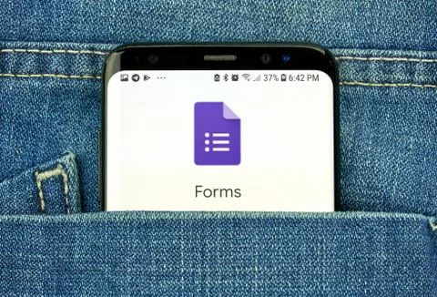 Google Forms on a phone screen in a pocket Stock Photos