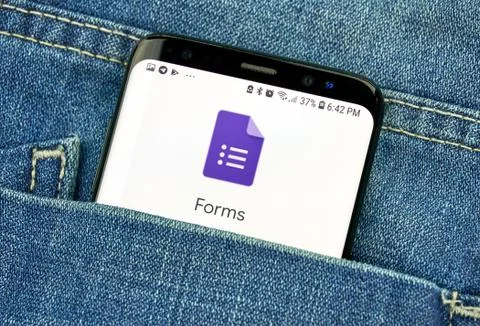 Google Forms on a phone screen in a pocket Фото