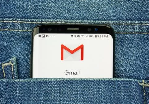 Google Gmail on a phone screen in a pocket Stock Photos