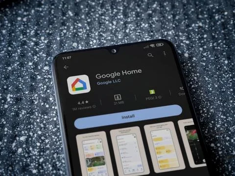 Google Home app play store page on smartphone on a metallic background Foto stock