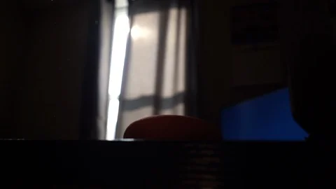 Google Home Mini Sitting on Desk Next to Sunny Window Stock Footage 102529313