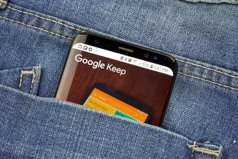 Google Keep on a phone screen in a pocket Stock Photos