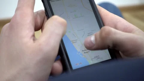 Google Maps On Mobile Cell Phone - Man looking searching Los Angeles USA Stock-Footage 73597334