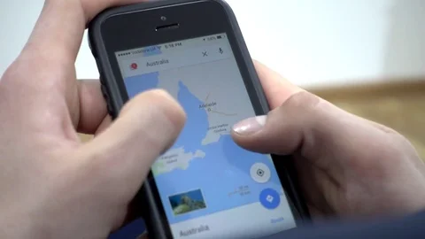Google Maps On Mobile Cell Phone - Man looking searching Australia Stock Footage 73597349