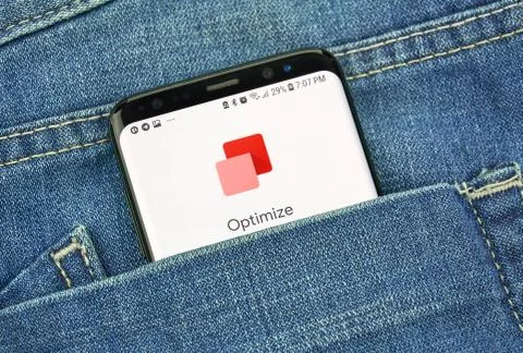 Google Optimize on a phone screen in a pocket Stock Photos