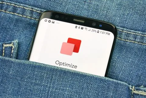 Google Optimize on a phone screen in a pocket Stock Photos