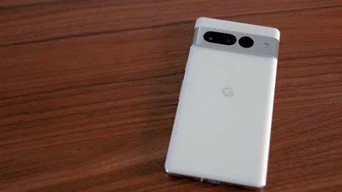 Google Pixel 7 Pro in Snow White on Wood Table Stock Footage 232057680