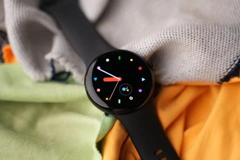 A Google Pixel Watch on top of a bedsheet Stock Photos