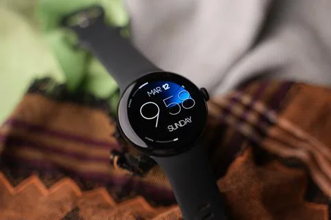 A Google Pixel Watch on top of a bedsheet Stock Photos
