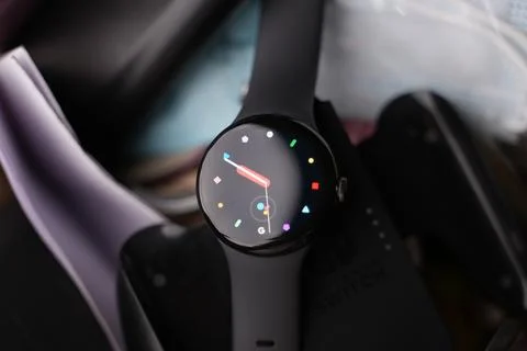 A Google Pixel Watch on top of a bedsheet Stock Photos