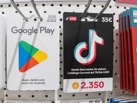 Google Play and TikTok Gift Cards Displayed in Retail Store Stock Photos