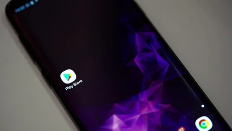 Google Play Store icon on a smartphone Stock Footage 107879185