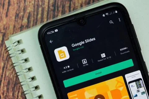 Google Slides dev app with magnifying on Smartphone screen. Stock-Fotos