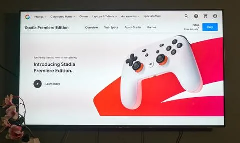Google Stadia controller and logo on a TV screen. Stadia offers 2 free months Stock Photos