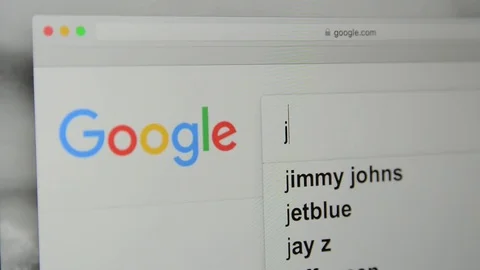 Google.com homepage. Typing word “job” in Google's search bar. Stock Footage