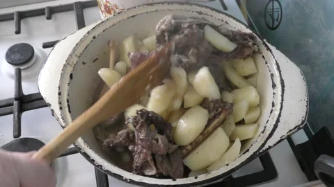A goose with potatoes is being prepared in a cauldron. healthy food concept Stock Footage 160454073
