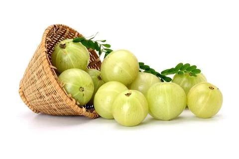 Gooseberries pulled from a basket on a white background Foto stock