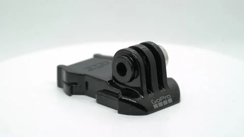 GoPro action camera mount buckle. Base plate rotate at white background isolated Vídeo Stock 169369100