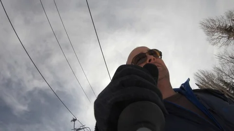 A gopro connected to a ski pole while a man skis down a mountain Video stock 127876155