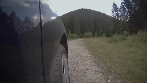GoPro mounted close the the wheel while driving through a forest road Stock Footage 94971669
