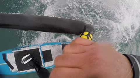 GoPro shot of surfer surfing while holding onto rope behind jet ski Video stock 163293725
