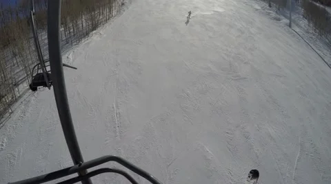 GoPro Skier going down a slope on a sunny day shot from chairlift Park City Utah Stock Footage 61863618