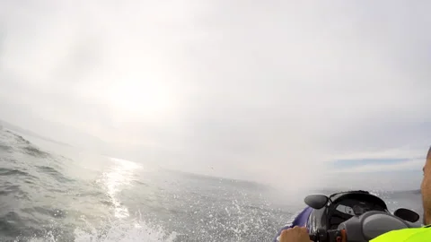 Gopro of surfer being pulled out of water by jet ski to surf ocean waves Stock Footage 160497051