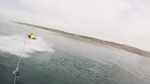 Gopro of surfer getting speed with help of jet ski to surf waves in Nazare Stock Footage 160496360