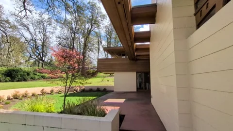 The Gordon House rear elevation highlights skylights, red flooring Stock Footage 337579483